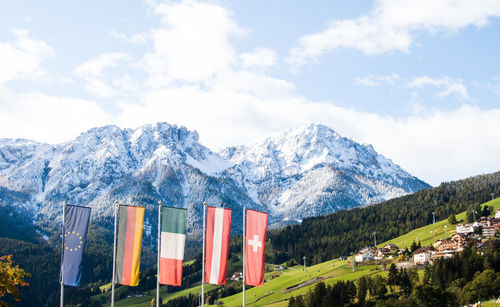 Flags against snowcapped mountains