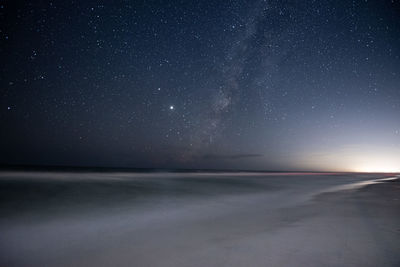 Scenic view of sea against sky at night