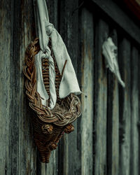 Close-up of old rope tied to wooden door