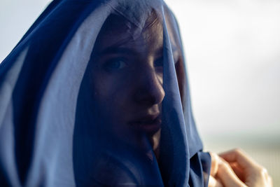 Close-up of woman covered with navy blue textile