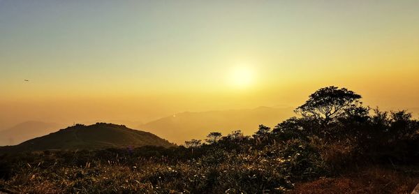 Scenic view of silhouette mountains against sky at sunset