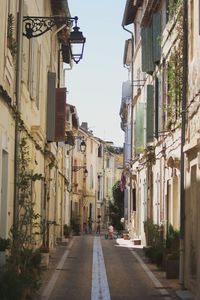 Old town alley with playing children amidst buildings in city