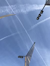 Low angle view of vapor trail against blue sky