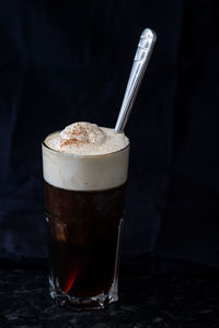 Close-up of coffee in glass on table