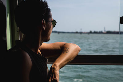 Close-up of man in boat against sky