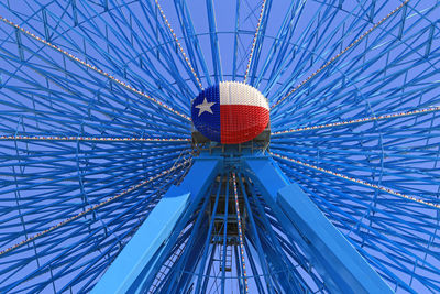 Low angle view of ferris wheel against blue sky