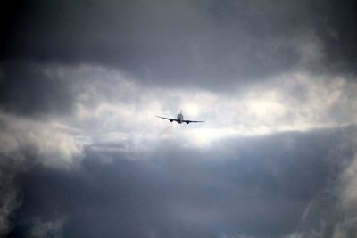 Low angle view of airplane flying in sky