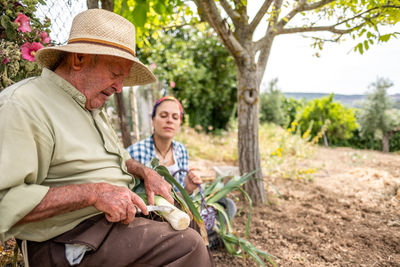 Man and woman sitting on farm