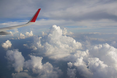 Airplane wings against clouds  