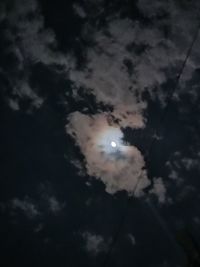 Low angle view of silhouette moon against sky at night