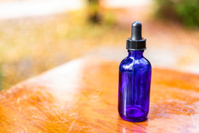 Close-up of blue bottle on table