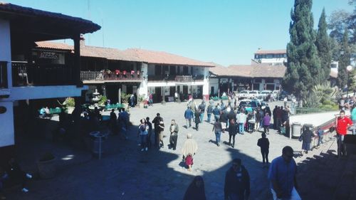 People at market against clear sky