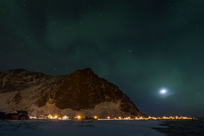 Scenic view of mountains against sky at night