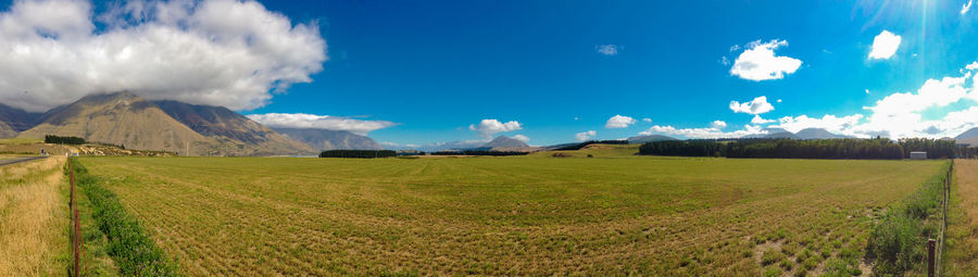 Panoramic shot of agricultural field against sky