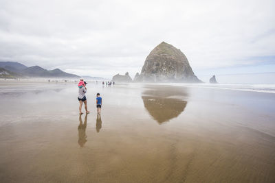 Rear view of women walking on beach