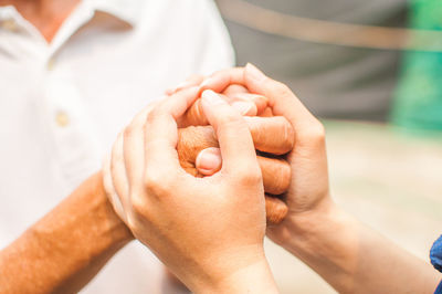 Close-up of people holding hands
