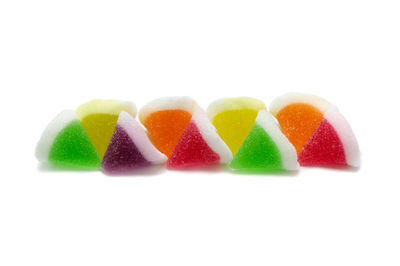 Close-up of multi colored candies against white background