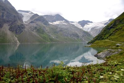 Scenic view of lake and mountains against sky