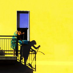Woman on yellow chair