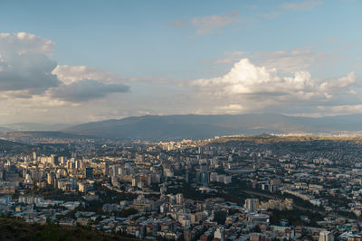 Aerial view of cityscape against sky during sunset