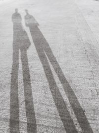 Shadow of person on road