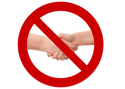 Close-up of hand holding red umbrella against white background