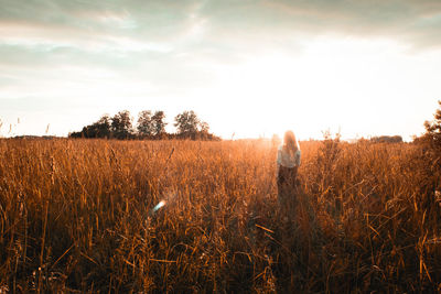 Man standing on field against sky