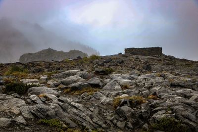 Rock formations on landscape against sky