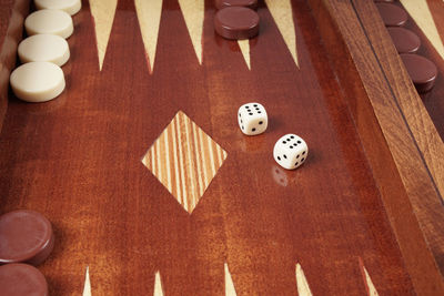 Close-up of rolling dices on wooden table