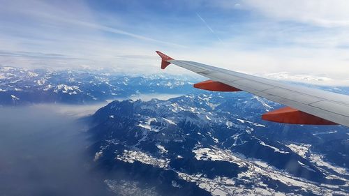 Aerial view of airplane wing against sky