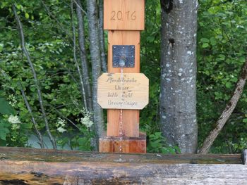 Information sign against trees