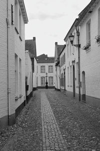 Empty alley amidst buildings in city