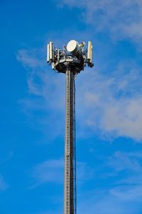 Low angle view of communications tower against sky