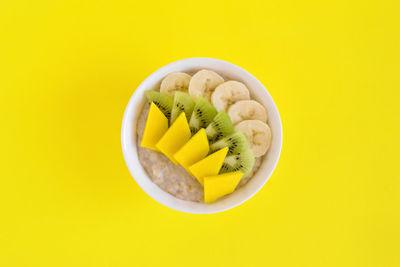 Directly above shot of lemon slice against yellow background