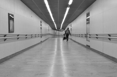 Man walking in illuminated corridor