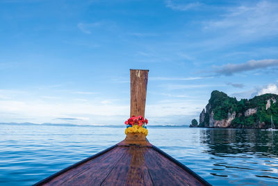 Wooden post in sea against sky