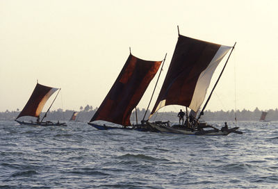 People on boats sailing on sea