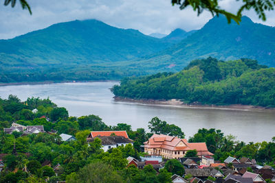 Scenic view of lake and buildings against sky