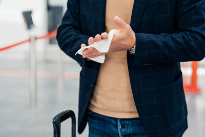 Midsection of businessman cleaning hands