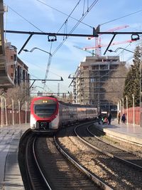 Train at railroad station against sky