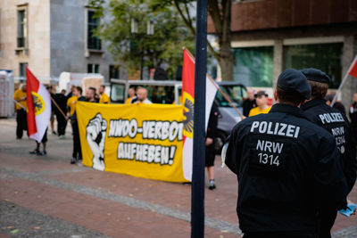 Rear view of people on street in city