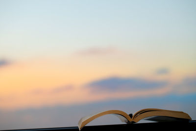 Close-up of empty chairs against sky during sunset