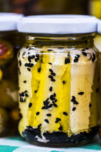 Close-up of cheese in jar for sale in market