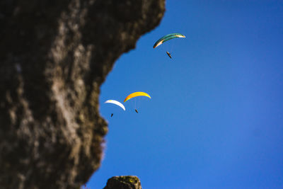 Low angle view of birds flying in sky