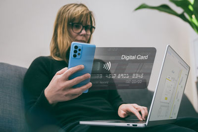 Midsection of woman using mobile phone