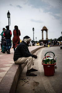 Rear view of people sitting on street