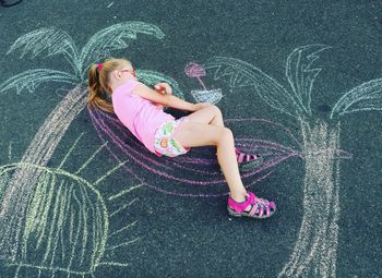 Girl drawing on road