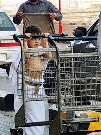 Reflection of men on car in city