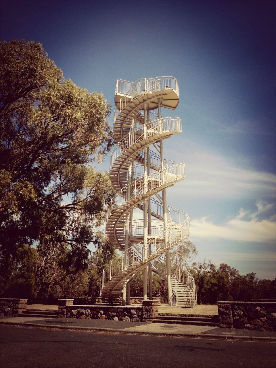 built structure, architecture, tree, sky, low angle view, famous place, tower, metal, travel destinations, building exterior, tall - high, tourism, clear sky, blue, travel, international landmark, day, metallic, sunlight, outdoors