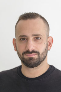 Close-up portrait of young man against white background